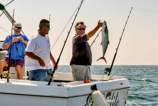 Sports fishermen show their catch of fish near Cabo San Lucas. 